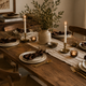 What a Host Home: Tablescape Rustic Modern with Brown Cotton Napkins, Gold cutlery, and handcrafted candle holders as centrepiece