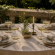 What a Host Home: Tablescape Outdoor Al fresco with gold coasters, handcrafted candle holder with taper candle and cotton gauze napkins