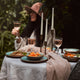 What a Host Home: Antique gold brass candle holders, green porcelain plates and blows blended with touches of earth tones, washed linen table textiles (natural material tablecloths and linen napkins) and gold rose cutlery sets.