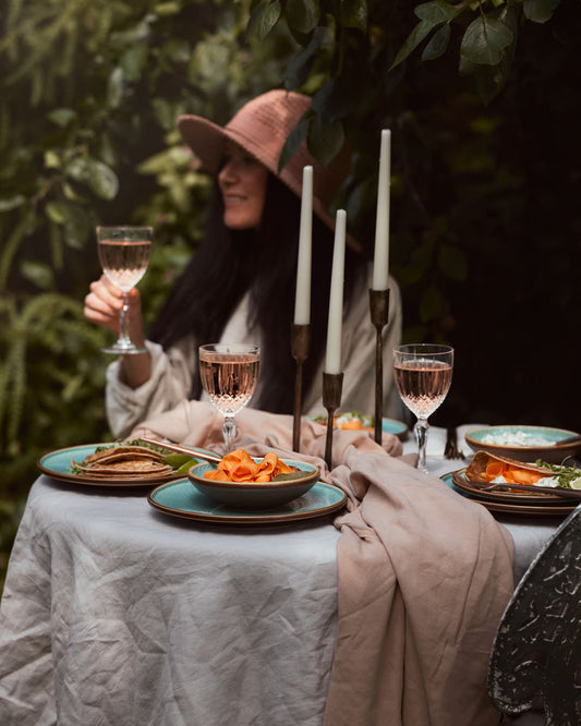 What a Host Home: Antique gold brass candle holders, green porcelain plates and blows blended with touches of earth tones, washed linen table textiles (natural material tablecloths and linen napkins) and gold rose cutlery sets.