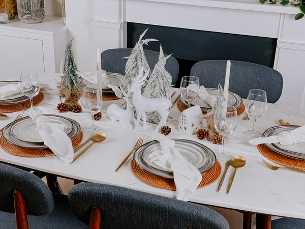What a Host Home Decor: Christmas Tablescape with White Deers, Snowed Christmas Table Trees, Rattan Placemats, Cotton Gauze Table Textiles and Stainless Steel Gold Cutlery