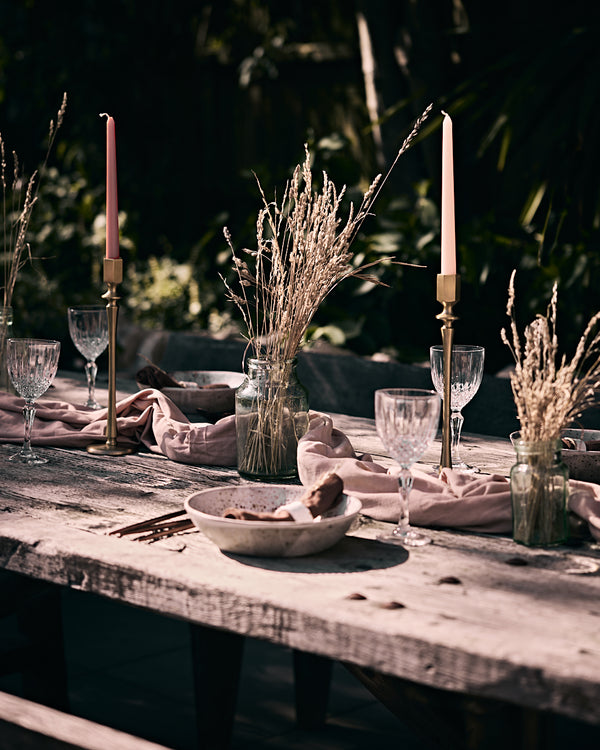 What a Host Home: Al Fresco Tablescape with gold modern candle holders, washed linen tablecloth, ceramic plates and gold rose stainless steel cutlery sets