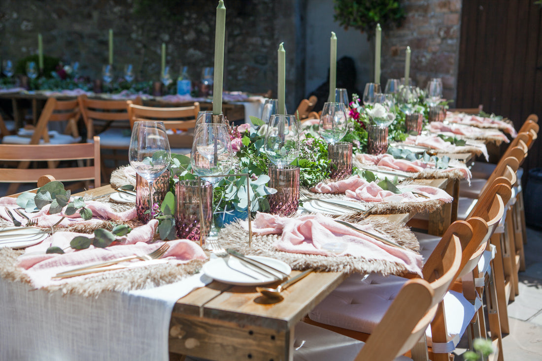 Wedding Tablescape: High quality table design with tableware, gold cutlery sets, cotton table runner and napkins, iron candle holders and round rattan placemats from What a Host Home and Hygge Decor
