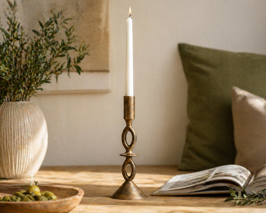 A pair of elegant gold candle holders creating a warm ambiance on a dinner table.