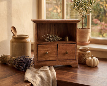 Wooden cabinet with decorative items on a wooden surface near a window