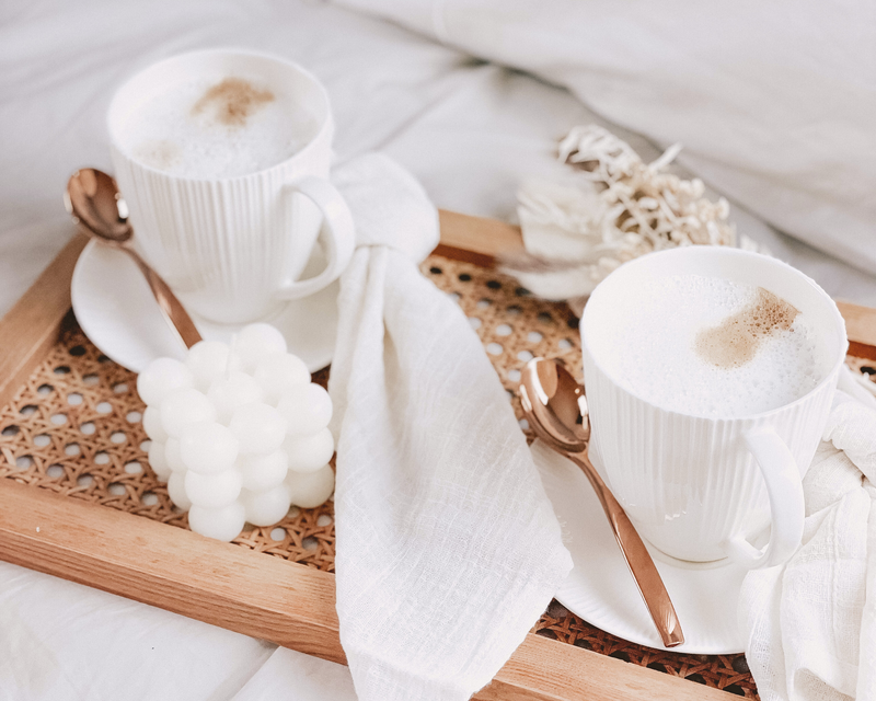 Maé Breakfast set. Wood Rectangle Rattan Tray, White Bubble Freesia Candle soy wax, Porcelain Mug White, Porcelain Saucer White, Stainless Steel Tea Spoon Rose Gold, Rustic White Cotton Gauze Napkin, Dried Bouquet flowers - What a Host  Edit alt text